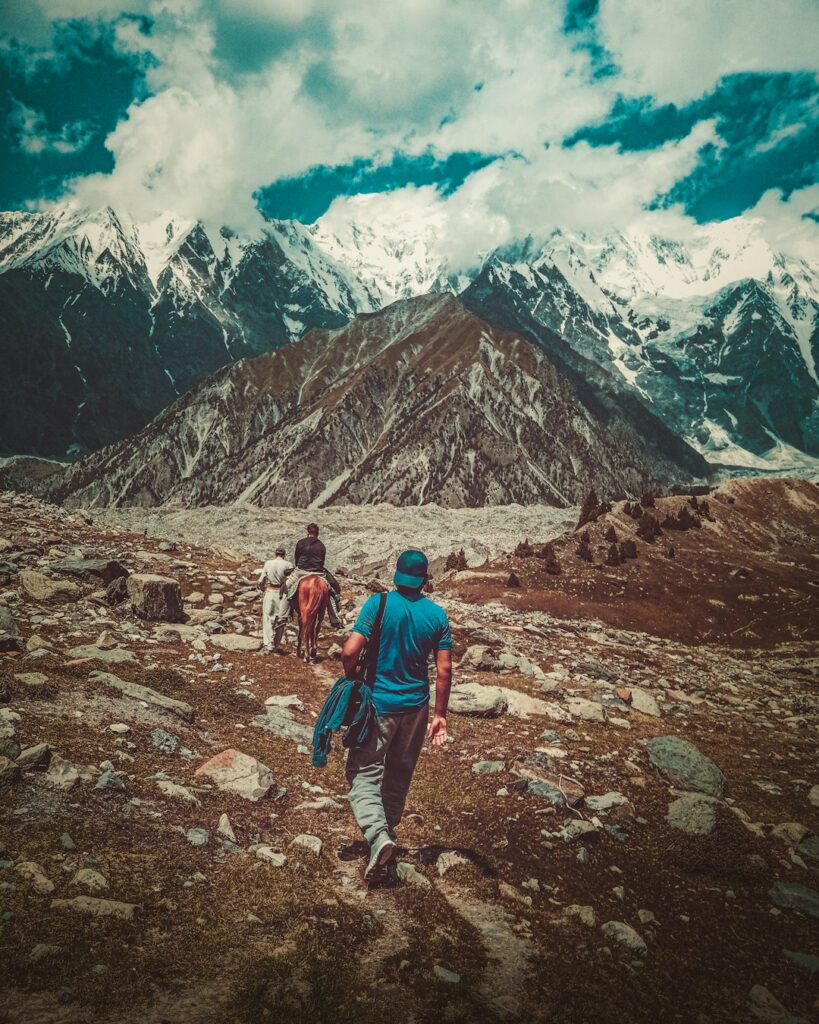 Trekkers walking through a remote mountain valley in Gilgit-Baltistan